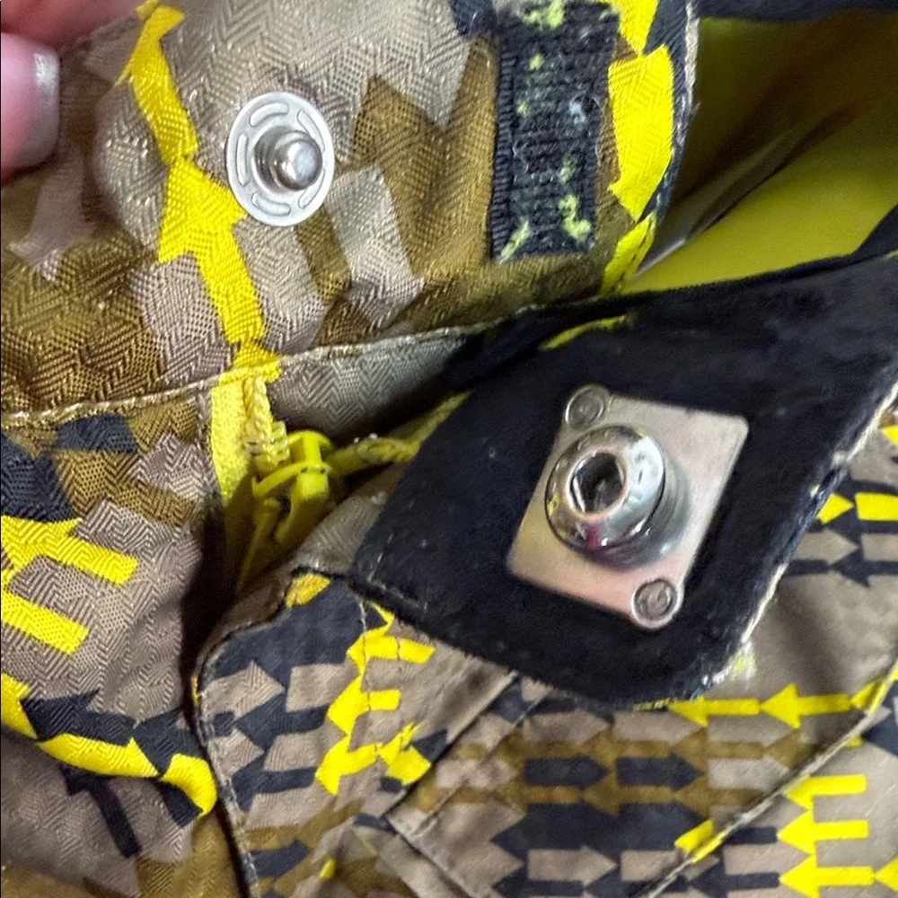 SPYDER Boys' Propulsion ski pants with an olive, black, and yellow plaid pattern